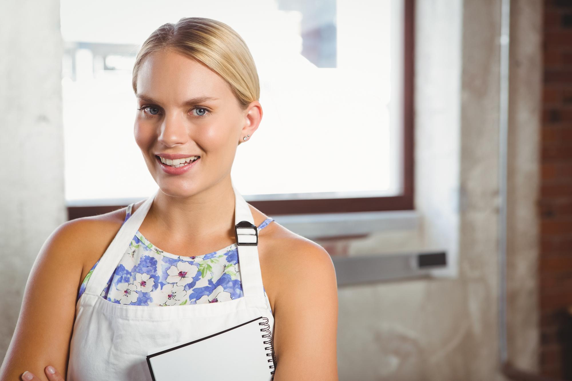 Instructor smiling in workshop doorway