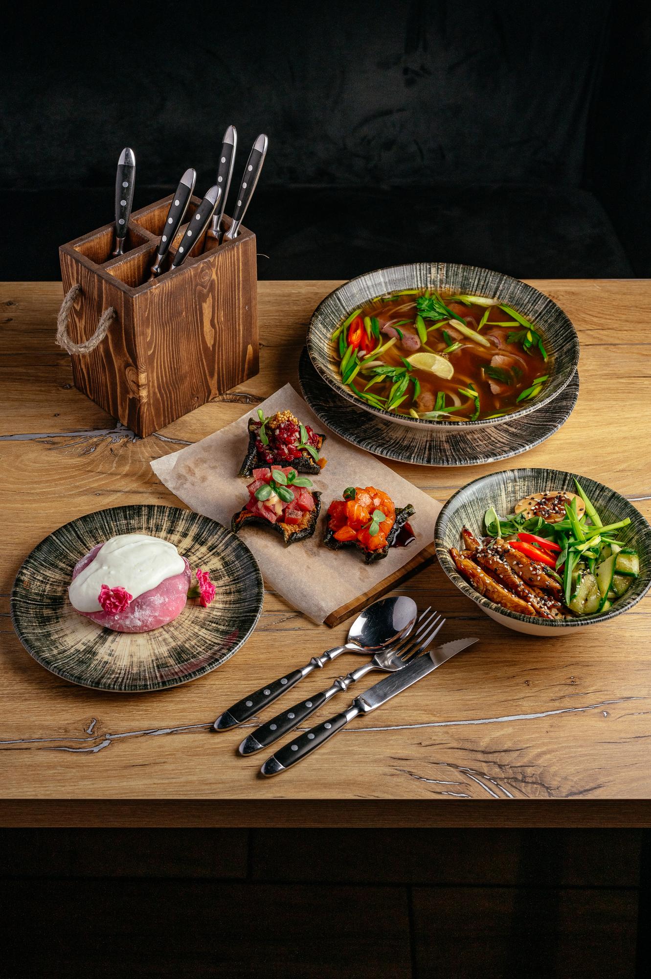 Selection of plated dishes on wooden table
